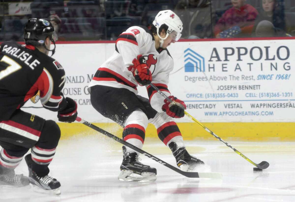 Joe Blandisi, right, with the Albany Devils brings the puck around a Binghamton Senators player during their game on Sunday, Dec. 4, 2016, in Albany, N.Y. (Paul Buckowski / Times Union)