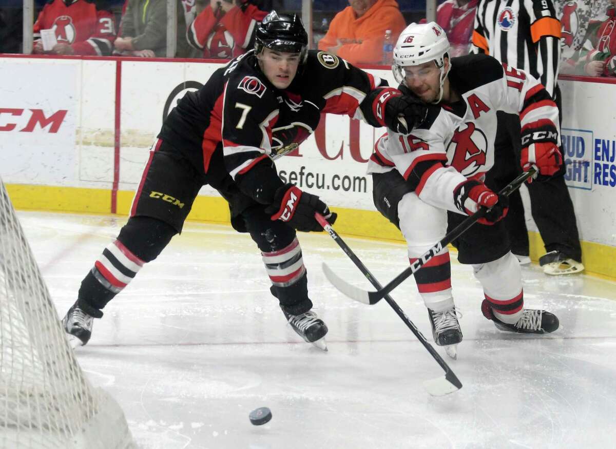 Chris Carlisle, left, with the Binghamton Senators and Ben Sexton, right, with the Albany Devils fight for control of the puck during their game on Sunday, Dec. 4, 2016, in Albany, N.Y. (Paul Buckowski / Times Union)