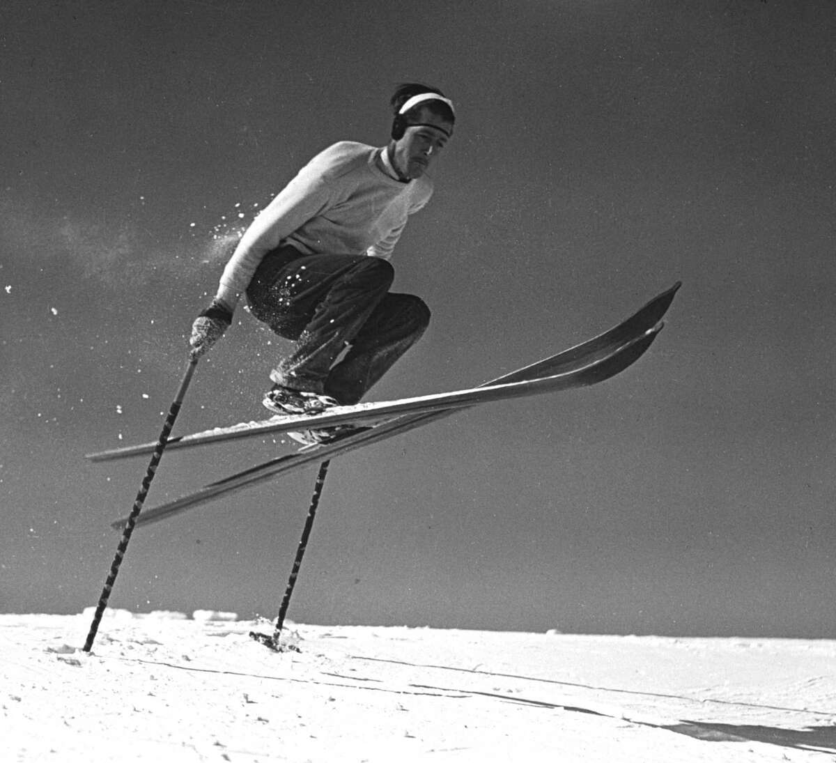 Skier in gelandesprung, a skiing jump performed in a crouching position with the use of both poles, 1936, in Lake Placid, N.Y. (New York State Archives)