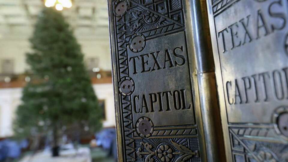 The senate door hinges shine in the light after the senate Christmas tree was raised Tuesday, Nov. 29, 2016 in the capitol in Austin.