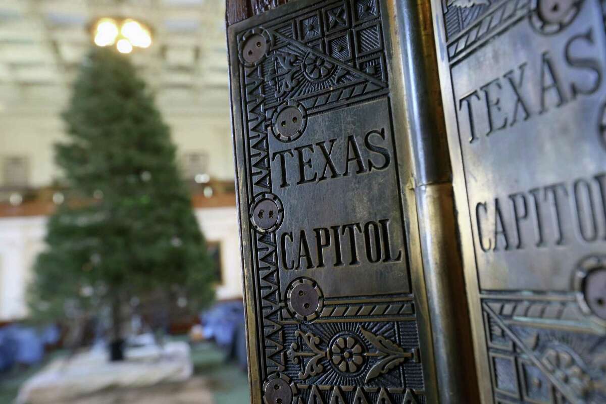 The senate door hinges shine in the light after the senate Christmas tree was raised Tuesday, Nov. 29, 2016 in the capitol in Austin.