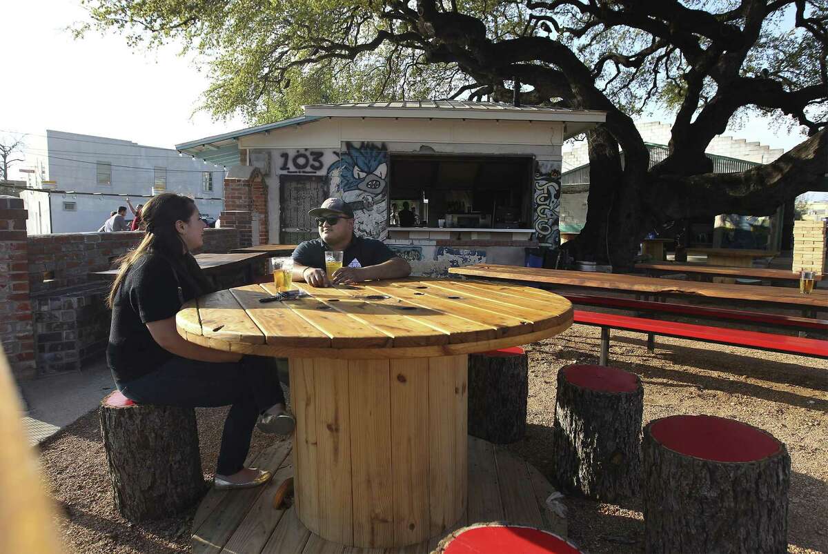 Patrons Andrea Ferrari (left) and Ernest Acevedo relax in the courtyard of the reopened TacoLand. Owner Christopher Erck hopes a second location on the River Walk will help expose the brand to out-of-town visitors.