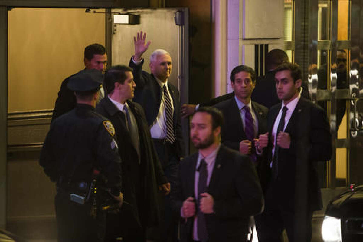 Vice President-elect Mike Pence, top center, leaves the Richard Rodgers Theatre after a performance of "Hamilton," in New York, Friday, Nov. 18, 2016. (AP Photo/Andres Kudacki)