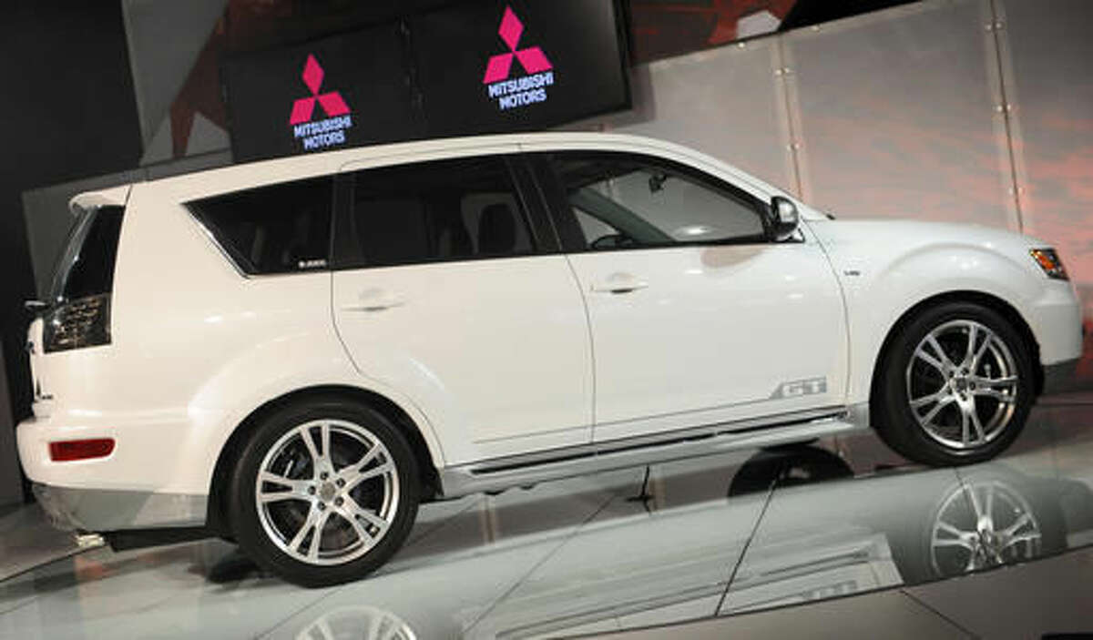 FILE - In an April 9, 2009 file photo, the Mitsubishi Outlander GT is introduced at the 2009 New York International Auto Show. Mitsubishi is recalling two SUV models to fix problems that could cause the windshield wipers to malfunction. The first recall covers about 100,000 Outlanders from the 2007 to 2013 model years. Mitsubishi says water can get between the hood and windshield and cause a ball joint to rust. That can knock out the wipers. Dealers will replace a rubber boot on the joint to keep water out.(AP Photo/Richard Drew, File)