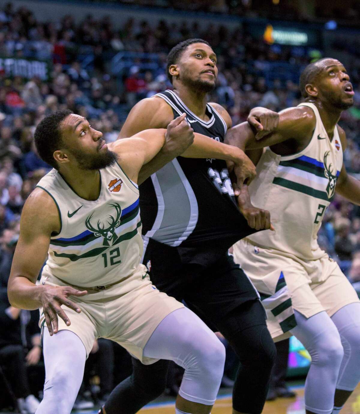 San Antonio Spurs forward Rudy Gay, center, is guarded by Milwaukee Bucks forward Jabari Parker, left and Khris Middleton, right, during the second half of an NBA basketball game Sunday, March 25, 2018, in Milwaukee. (AP Photo/Darren Hauck)