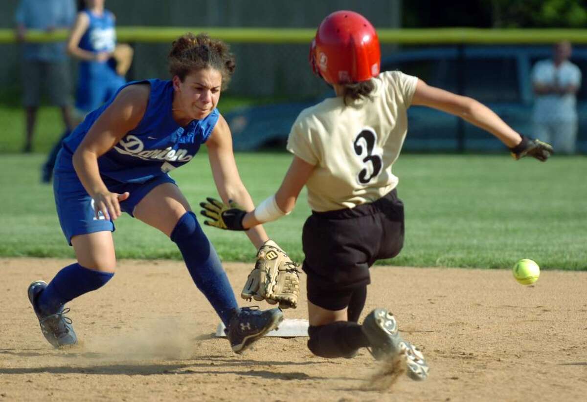 Trumbull (No. 3) Erica Andrasi slides safely into second base in front of Darien short stop (No.7) Nichole Buch during high school softball action, in Darien, Conn. Friday, May 21st, 2010.