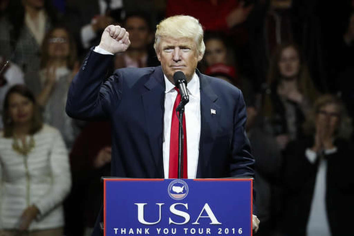 President-elect Donald Trump raises his fist as he speaks during the first stop of his post-election tour, Thursday, Dec. 1, 2016, in Cincinnati. (AP Photo/John Minchillo)