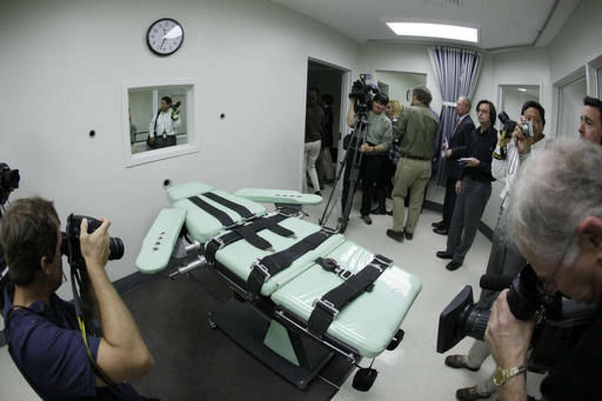 FILE - In this Sept. 21, 2010, file photo, people photograph the interior of the lethal injection facility at San Quentin State Prison in San Quentin, Calif. Even before election results were fully tallied and it wasn't yet certain if capital punishment opponents had lost on two ballot measures, they pre-emptively asked the State Supreme Court to block Proposition 66, a measure that would speed up executions. (AP Photo/Eric Risberg, File)