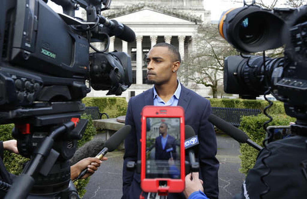 Seattle Seahawks NFL football wide receiver Doug Baldwin talks to reporters Monday, Nov. 21, 2016, after he testified at a joint legislative task force on the use of deadly force in community policing at the Capitol in Olympia, Wash. Baldwin, whose father was a police officer, has been outspoken on the issues of police training, racial profiling, and the use of force by law enforcement officers. (AP Photo/Ted S. Warren)