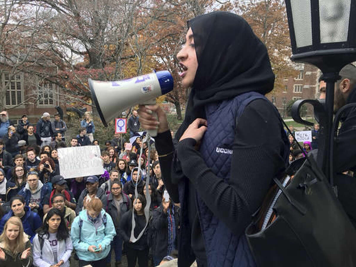 Eeman Abbasi speaks during a protest on the University of Connecticut campus against the election of Republican Donald Trump as president Wednesday, Nov. 9, 2016, in Storrs, Conn. Abbasi, a junior psychology and neurobiology major, said as a Muslim student she feels that the American people told her Tuesday night that even though she was born in this country she doesn't belong here. (AP Photo/Pat Eaton-Robb)