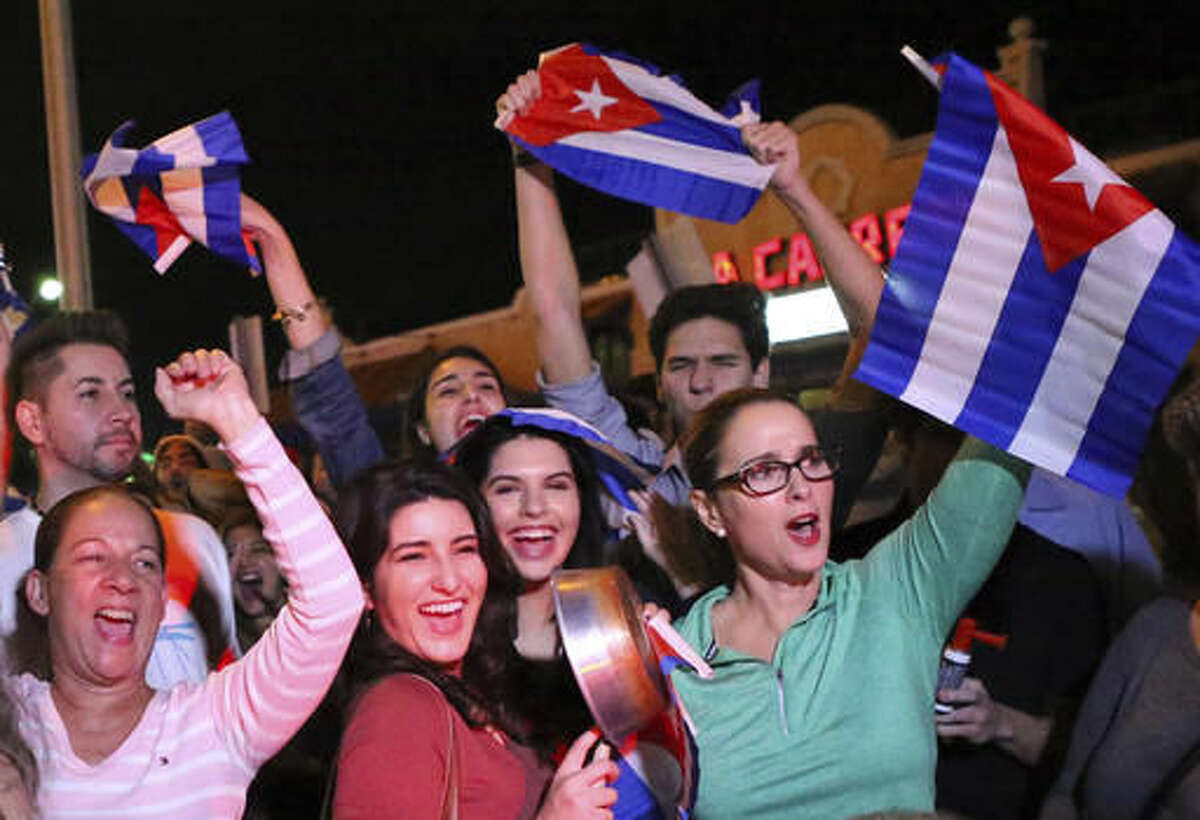 FILE- In this Nov. 25, 2016, file photo, the Cuban community in Miami celebrates the announcement that Fidel Castro died in front La Carreta Restaurant early in Miami. For the hundreds of thousands of children born of Cuban exiles, some who are two and three generations removed from the island, Fidel Castro’s death potentially opens a door to a world previously off-limits. (David Santiago/El Nuevo Herald via AP, File)