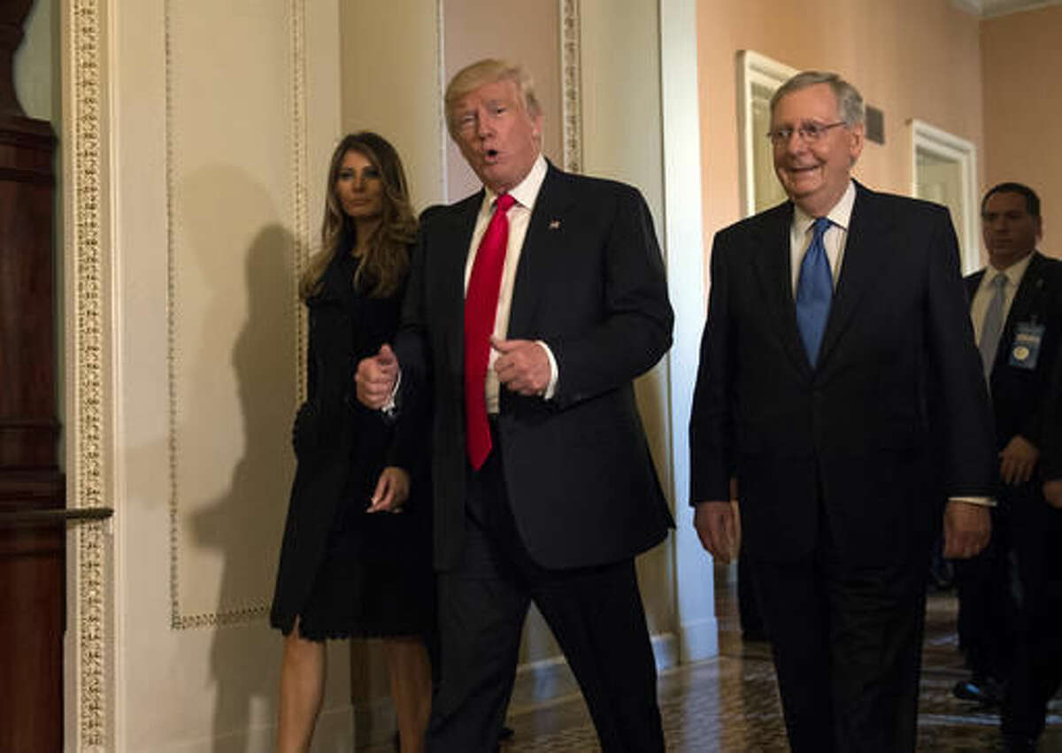 In this Nov. 10, 2016, photo, President-elect Donald Trump, accompanied by his wife Melania, and Senate Majority Leader Mitch McConnell of Ky., gestures while walking on Capitol Hill in Washington. Washington’s new power trio consists of a bombastic billionaire, a telegenic policy wonk, and a taciturn political tactician. How well they can get along will help determine what gets done over the next four years, and whether the new president’s agenda founders or succeeds. (AP Photo/Molly Riley)