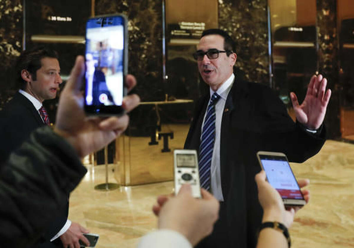 Steven Mnuchin, national finance chairman of President-elect Donald Trump's campaign, waves after speaking to media at Trump Tower, Wednesday, Nov. 16, 2016, in New York. (AP Photo/Carolyn Kaster)