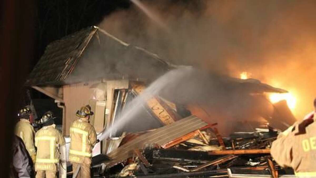 A fire that started in the kitchen of Luigi's destroys the longtime restaurant in Oelwein, Iowa, Saturday, Nov. 12, 2016.. The restaurant's well-known sign in the parking lot was the only thing left standing after Saturday's fire. Firefighters knocked down the walls of the restaurant to extinguish the blaze, so little was left intact. (Jeff Reinitz/