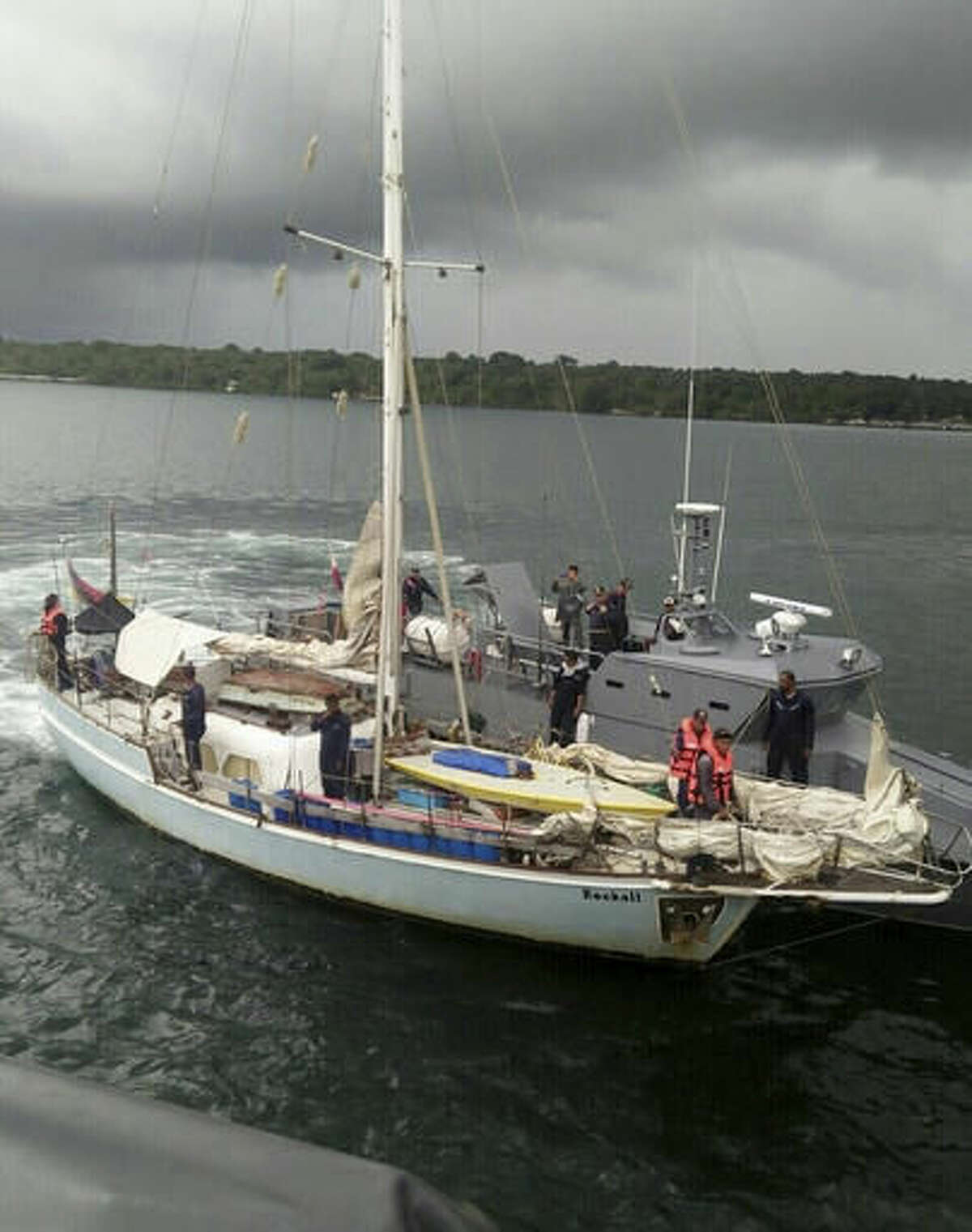 In this photo provided by the Armed Forces of the Philippines Western Mindanao Command (WESMINCOM) and authorized for distribution by Army Maj. Filemon Tan Jr. Monday, Nov. 7, 2016, Philippine Navy board the yacht marked "Rockall" after being found abandoned off the Sulu Sea in southern Philippines over the weekend. The Philippine military is verifying a claim by Abu Sayyaf militants that they have kidnapped a German man from the yacht and shot and killed his female companion, whose suspected body was found on the abandoned boat, military officials said Monday. Regional military spokesman Maj. Filemon Tan said Abu Sayyaf spokesman Muamar Askali had claimed the militants kidnapped Juegen Kantner and killed his companion while the couple were cruising off neighboring Malaysia's Sabah state. (WESMINCOM via AP)