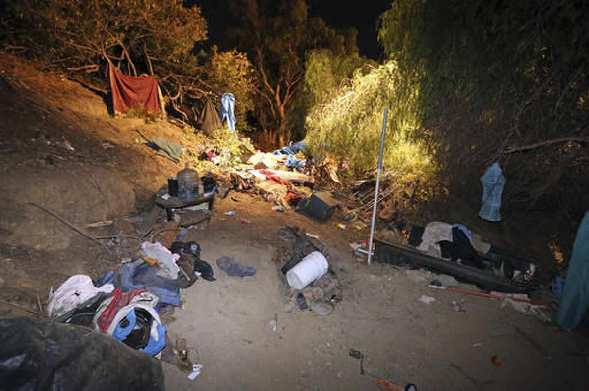 A homeless encampment where a car went off the side of the southbound lanes of Interstate 405 and landed, is seen near Sherman Way in the Van Nuys area of Los Angeles, Tuesday, Nov. 29, 2016. A woman who may have been homeless was killed and three people in the car were injured. (AP Photo/Reed Saxon)