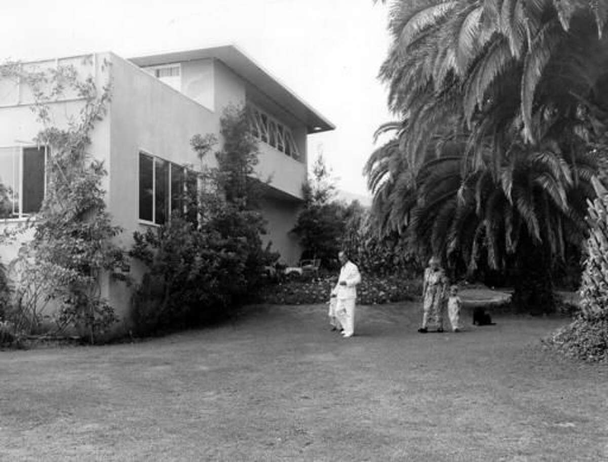 FILE - In this undated file photo, Thomas Mann, his wife Katia Mann and their two grandchildren stroll on the lawn of their Pacific Palisades home at Santa Monica, Calif. Germany has purchased a Los Angeles house once owned by Thomas Mann, averting demolition of the home where the Nobel Prize-winning novelist lived for a decade after fleeing the rise of Nazism. An online petition called on the German government to save the home in Pacific Palisades, describing it as a monument to exiles in California and resistance to the Nazi regime. It was bought for $13.25 million and officials say it will be renovated and used as an artist residency. (AP Photo, File)