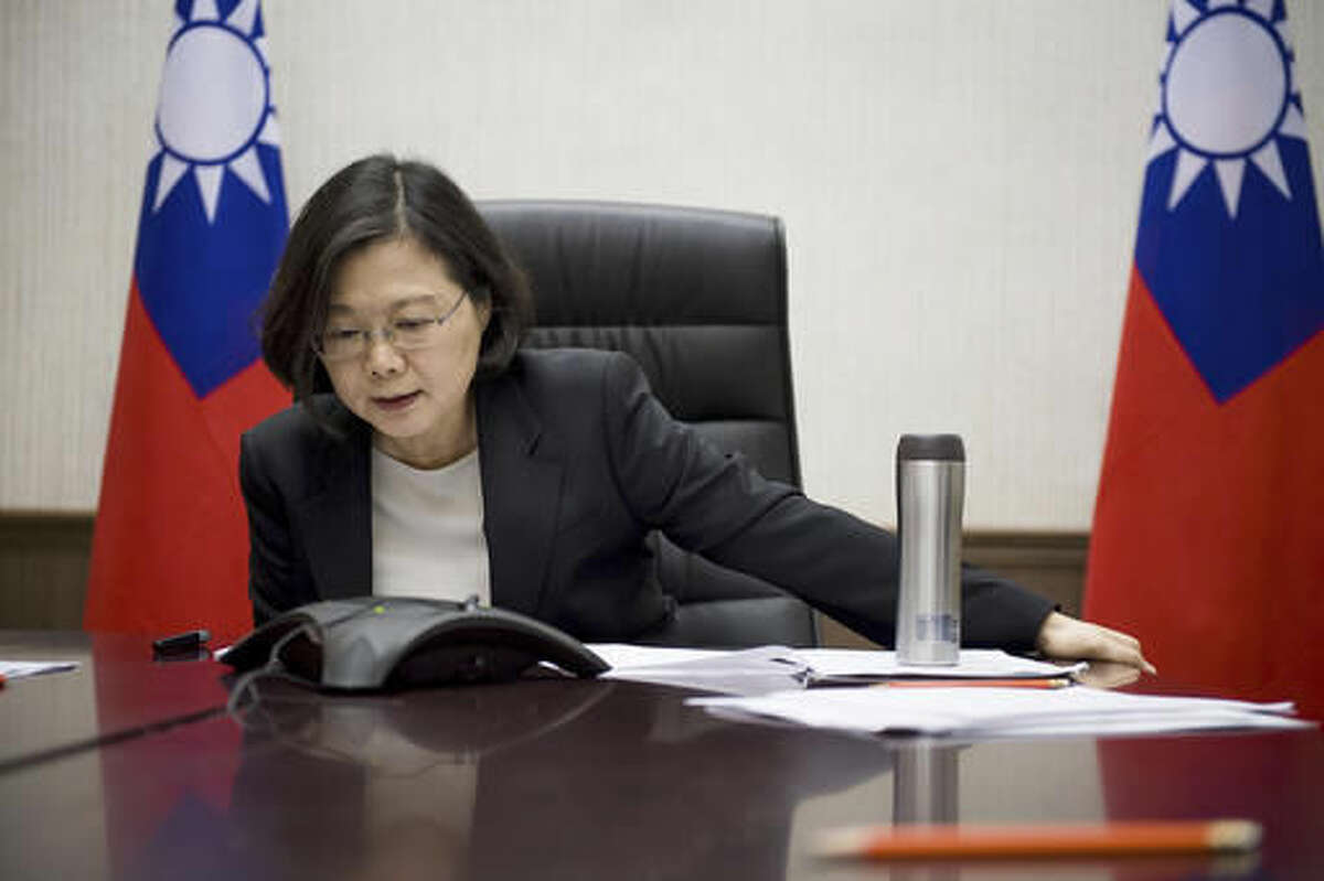 In this Friday, Dec. 2, 2016 photo released by Taiwan Presidential Office Saturday, Dec. 3, 2016, Taiwan's President Tsai Ing-wen speaks with U.S. President-elect Donald Trump through a speaker phone in Taipei, Taiwan. (Taiwan Presidential Office via AP)