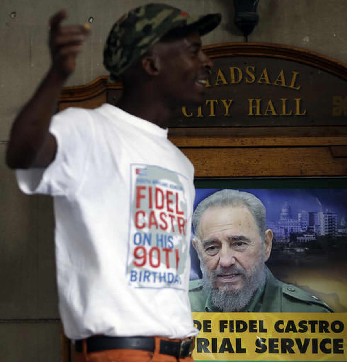 A man stands outside the venue hosting the memorial service for the late Cuban revolutionary leader Fidel Castro in Johannesburg, South AfricaWednesday, Nov. 30, 2016. Castro, who led a rebel army to improbable victory, embraced Soviet-style communism and defied the power of 10 U.S. presidents during his half century rule of Cuba, died Friday at age 90. (AP Photo/Themba Hadebe)