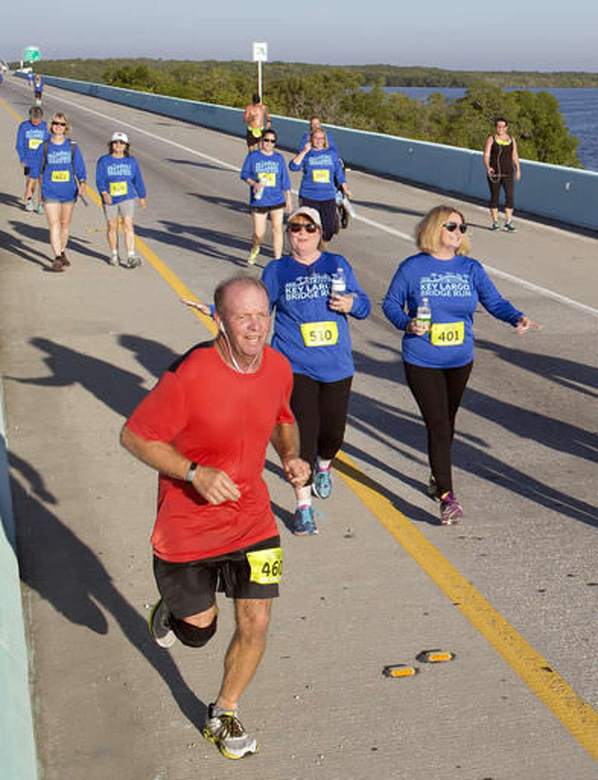 In this photo provided by the Florida Keys News Bureau, competitors in the 5k division of the Key Largo Bridge Run head to the finish line Saturday, Nov. 12, 2016. Some 465 registered entrants competed in 5k, 10k and half-marathon classes that took participants out and back over the 1.4-mile-long Jewfish Creek Bridge and land areas. (Bob Care/Florida Keys News Bureau via AP )