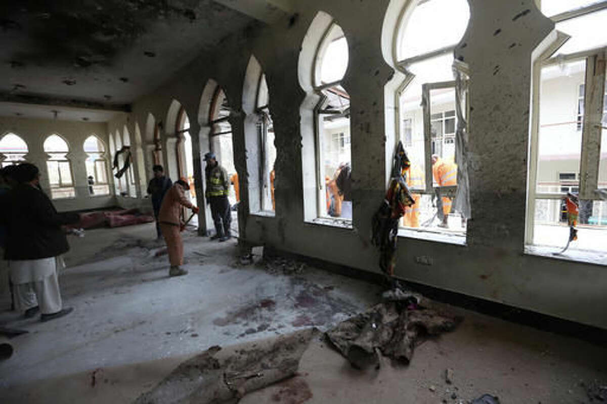 Afghan Municipality workers sweep Baqir-ul Ulom mosque after a suicide attack, in Kabul, Afghanistan, Monday, Nov. 21, 2016. An Afghan official says that dozens of civilians have been killed after a suicide bomber attacked a Shiite mosque in the capital. (AP Photo/Rahmat Gul)