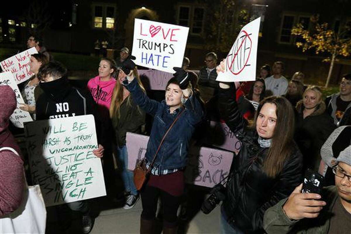 Protesters hold up signs and chant "Love Trumps Hate" during an anti-Trump protest on the University of Wisconsin-Eau Claire campus, Thursday, Nov. 10, 2016, in Eau Claire, Wis. President-elect Donald Trump fired back on social media after demonstrators in both red and blue states hit the streets for another round of protests, showing outrage over the Republican’s unexpected win. (Marisa Wojcik/The Eau Claire Leader-Telegram via AP)