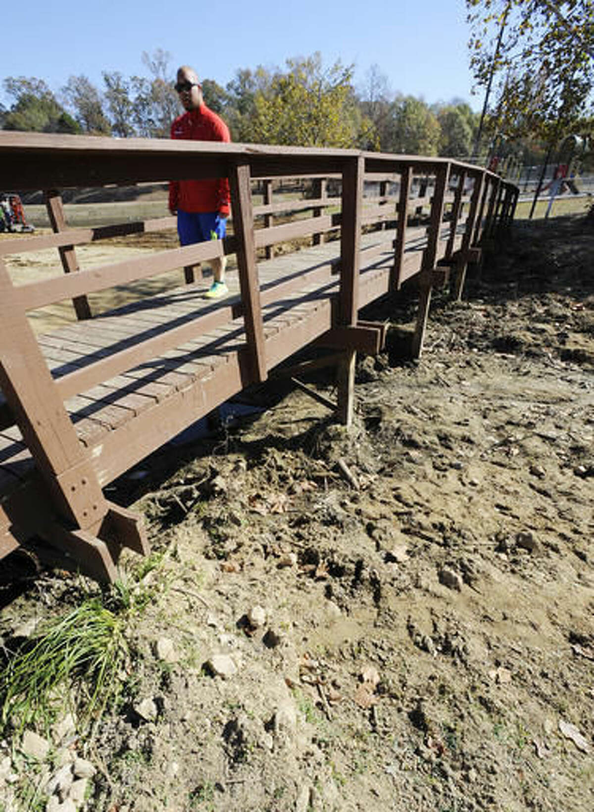 Chris Smith walks over a pond dried up by a worsening drought in Helena, Ala., on Thursday, Nov. 17, 2016. Federal statistics show nearly 90 percent of the state is now in a severe drought. And the U.S. Drought Monitor shows 65 percent of the state is in an extreme or exceptional drought. (AP Photo/Jay Reeves)