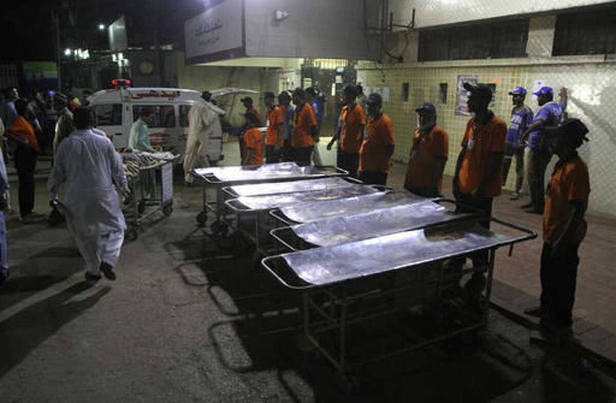 Staff members of a local hospital wait for casualties of bomb blast at a Sufi shrine, in Karachi, Pakistan, Saturday, Nov. 12, 2016. Pakistani police say a bomb blast at a Sufi shrine has killed several people and wounded many others in the country's southwest. Sarfaraz Bugti, home minister for Baluchistan province, confirmed that the blast occurred with hundreds in attendance at the shrine of Sufi saint Shah Bilal Noorani. (AP Photo/Fareed Khan)