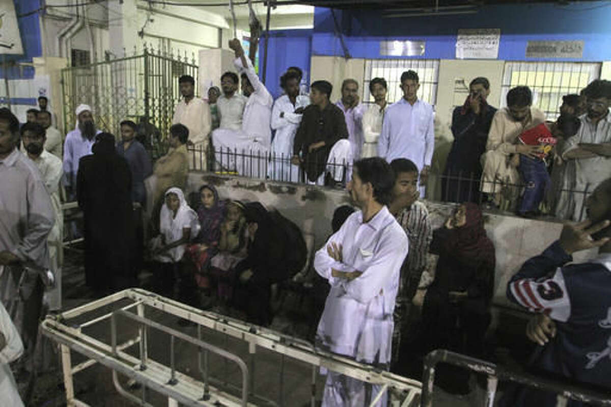 People gather outside an emergency ward of a local hospital after hearing news of a bomb blast at a Sufi shrine, in Karachi, Pakistan, Saturday, Nov. 12, 2016. Pakistani police say a bomb blast at a Sufi shrine has killed several people and wounded many others in the country's southwest. Sarfaraz Bugti, home minister for Baluchistan province, confirmed that the blast occurred with hundreds in attendance at the shrine of Sufi saint Shah Bilal Noorani. (AP Photo/Fareed Khan)