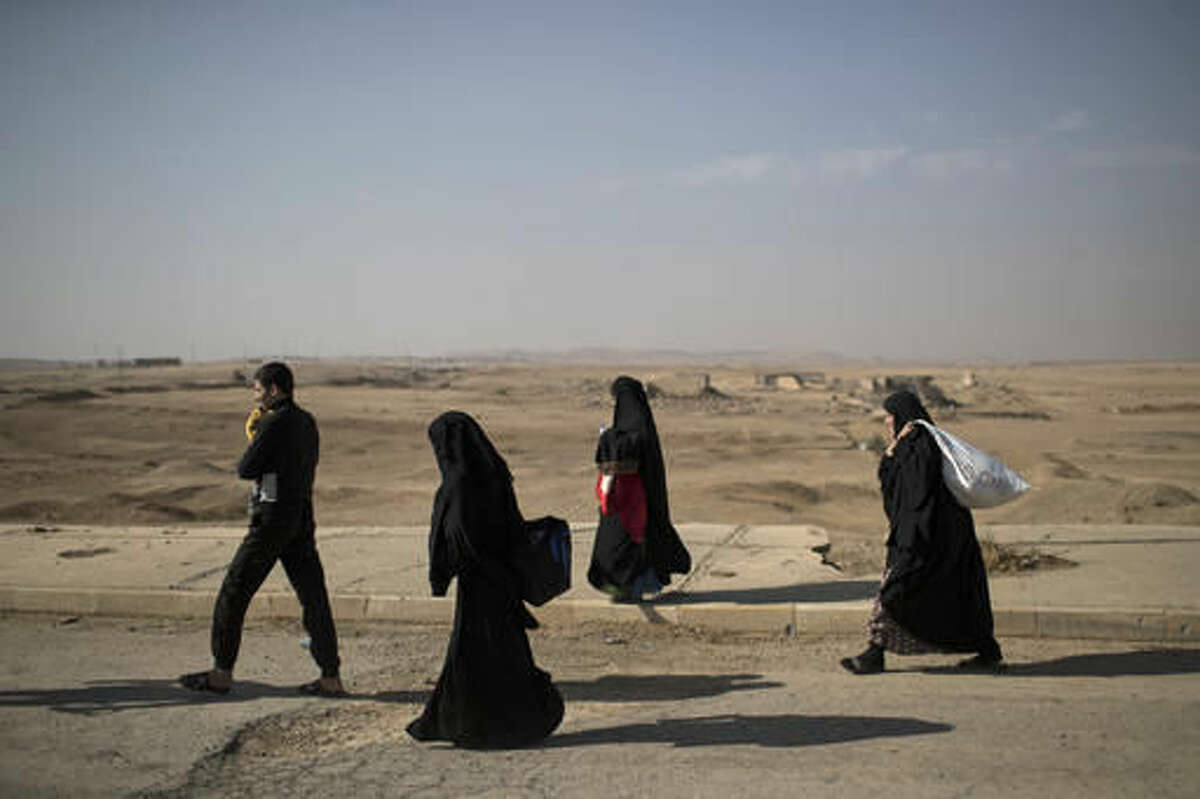 Displaced people leave their homes due to fighting, in Hamam al-Alil, south of Mosul, Iraq, Sunday, Nov. 6, 2016. The Mosul offensive has slowed in recent days as Iraqi forces have pushed into more densely populated areas, where they cannot rely as much on airstrikes and shelling because of the risk posed to civilians. (AP Photo/Felipe Dana)