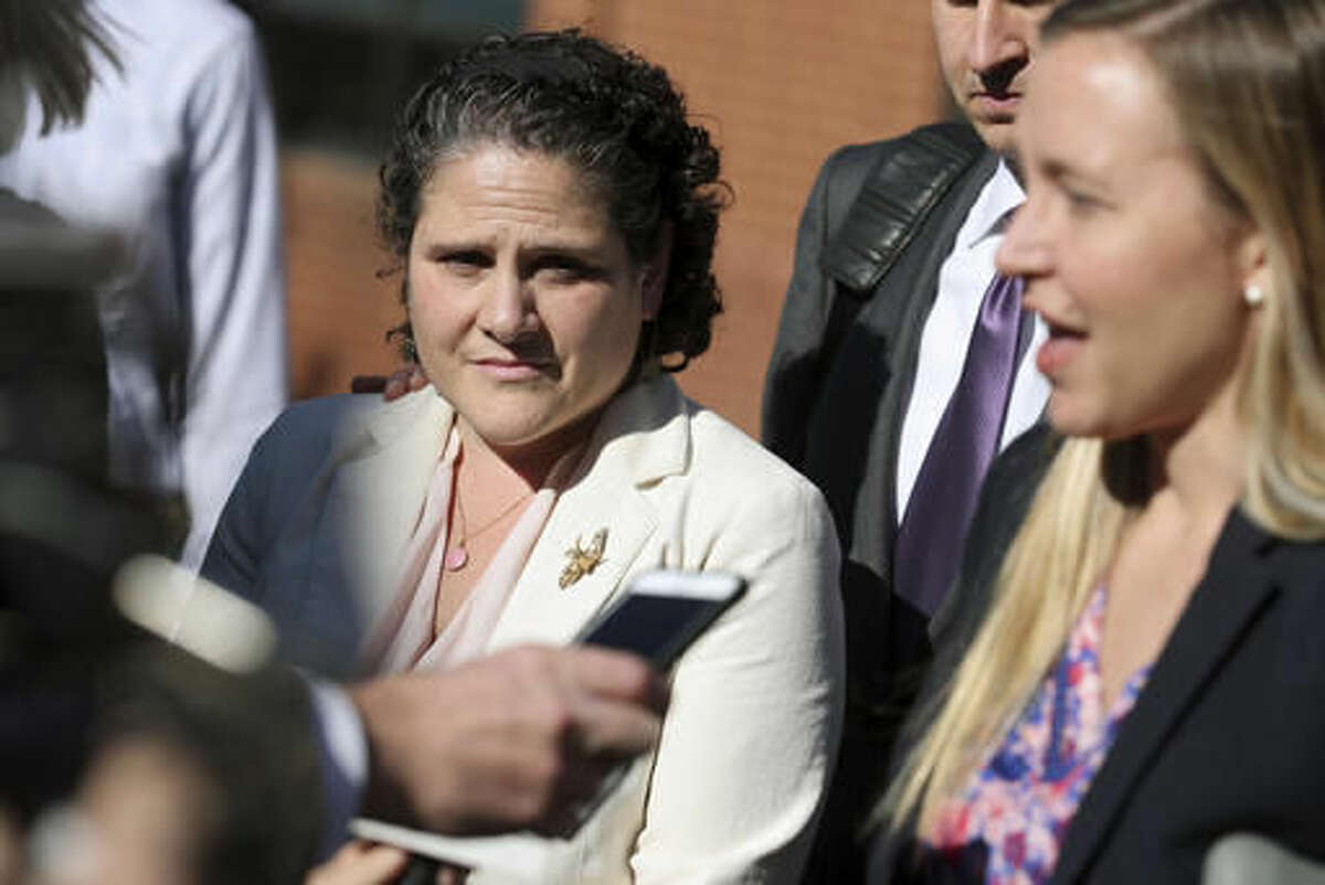 University of Virginia administrator Nicole Eramo, left, listens to attorney Libby Locke, right, speak with the media outside the federal courthouse in Charlottesville, Va., on Friday, Nov. 4, 2016. A federal jury on Friday found Rolling Stone magazine, its publisher and a reporter defamed Eramo in a discredited story about gang rape at a fraternity house of the university. (Ryan M. Kelly /The Daily Progress via AP)
