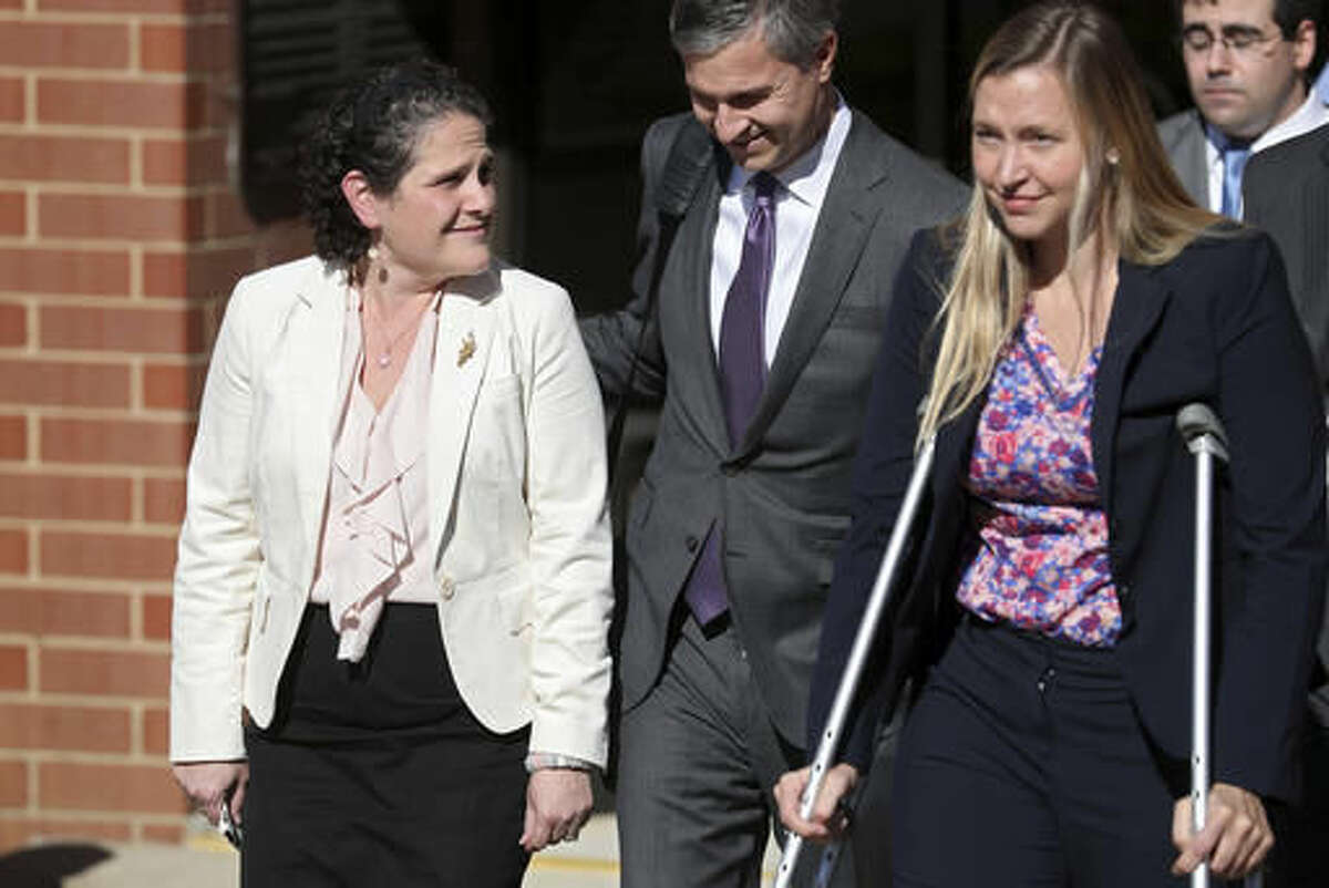 University of Virginia administrator Nicole Eramo, left, leaves the federal courthouse in Charlottesville, Va., with attorney Libby Locke, right, on Friday, Nov. 4, 2016. A federal jury on Friday found Rolling Stone magazine, its publisher and a reporter defamed Eramo in a discredited story about gang rape at a fraternity house of the university. (Ryan M. Kelly /The Daily Progress via AP)