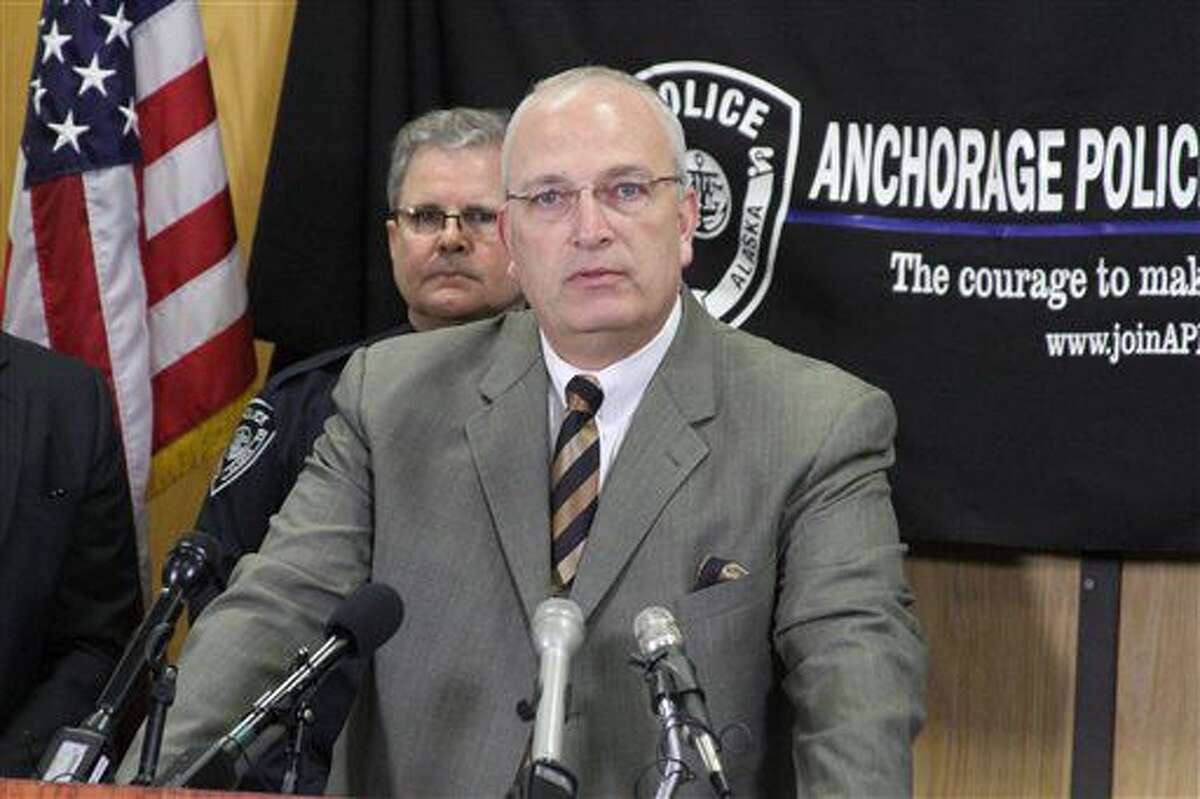 Anchorage Police Lt. John McKinnon speaks at a news conference in Anchorage, Alaska, on Tuesday, Nov. 15, 2016. McKinnon said the gun used in the shooting of an officer over the weekend, was linked through ballistics to the same gun used in five unsolved homicides this year. Behind McKinnon is Anchorage Police Chief Chris Tolley. (AP Photo/Mark Thiessen)