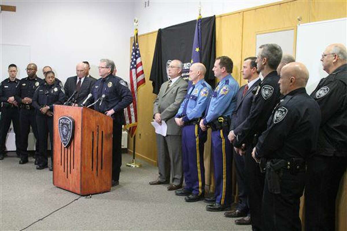 Anchorage Police Chief Chris Tolley, surrounded by Alaska law enforcement officers, speaks at a news conference in Anchorage, Alaska, on Tuesday, Nov. 15, 2016. Tolley said the gun used in the shooting of an officer over the weekend has been linked to five killings in Alaska's biggest city this year. (AP Photo/Mark Thiessen)