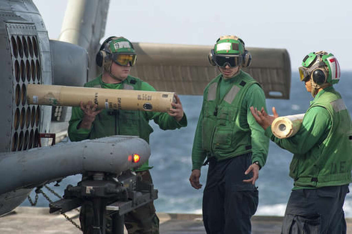 FILE - In this Dec. 14, 2012, file photo provided by the U.S. Navy, sailors unload sonobuoys from an MH-60R Sea Hawk helicopter aboard the guided-missile cruiser USS Mobile Bay in the Arabian Sea. The U.S. Navy has finalized a plan to expand sonar testing and other warfare training off the coasts of Washington, Oregon and northern California after a lengthy review that included a determination from the National Marine Fisheries Service that the exercises would not have major impacts on endangered orcas and other marine mammals. (Spc. 2nd Class Armando Gonzales/U.S. Navy via AP, File)