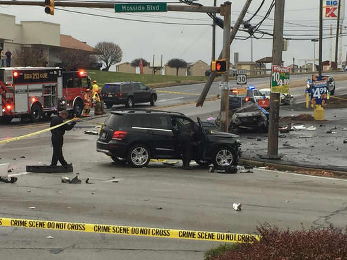FILE - In this Nov. 24, 2016 file photo, police investigate the scene of a multi-vehicle crash at the intersection of Route 30 and Route 48, in North Versailles, Pa. Early indications are police didn’t wrongly push a man who may have driven 100 mph to avoid officers before crashing into a car and killing a family of three on Thanksgiving, a prosecutor said Tuesday, Nov. 29. (Darrell Sapp/Pittsburgh Post-Gazette via AP, File)