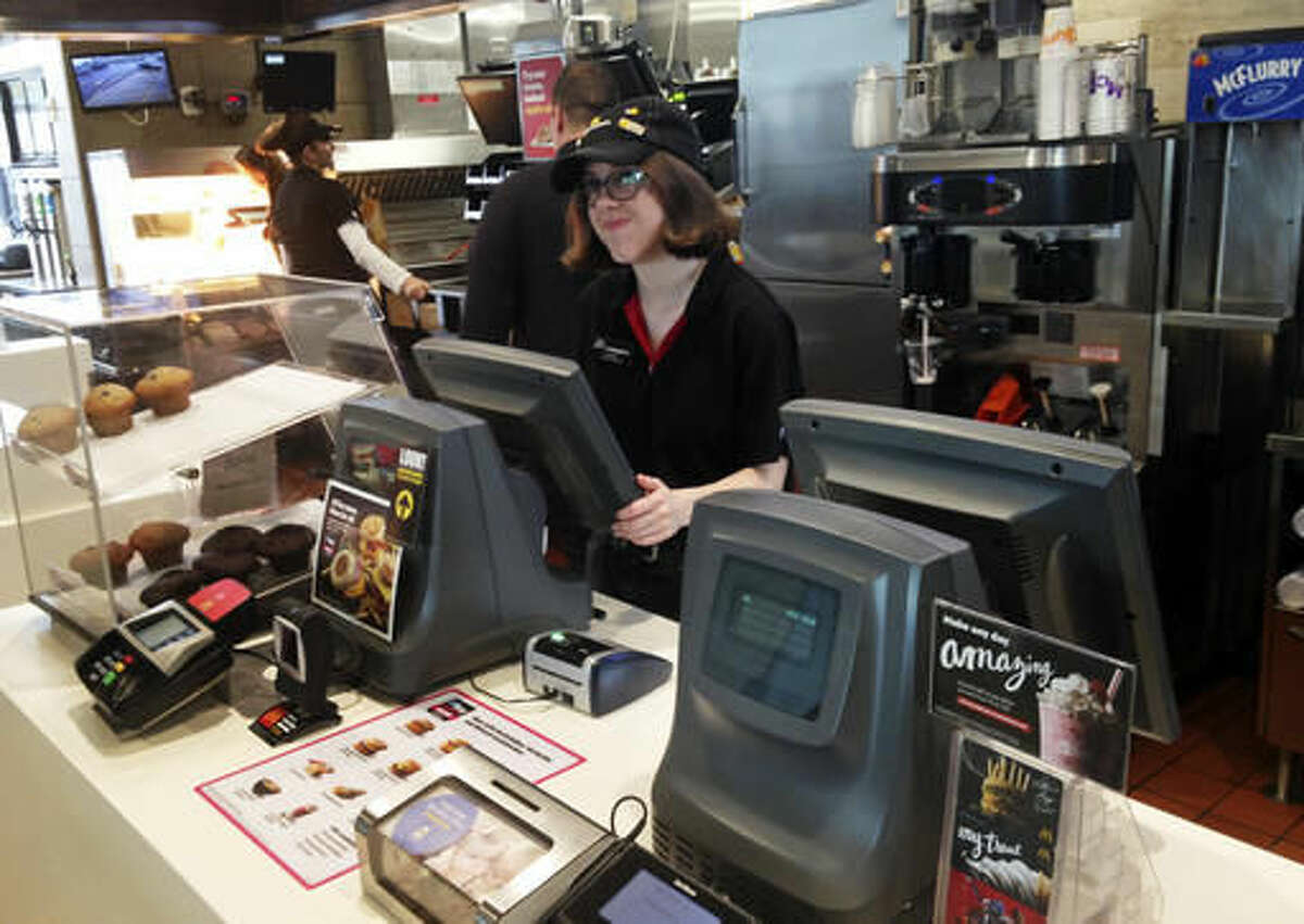 In this Oct. 6, 2016 photo, Lauren Curtis waits on a customer at the front counter of a McDonald's in Potterville, Mich. Curtis, 18, and her four siblings are non-identical quintuplets, all of whom work at the Lansing-area restaurant. (AP Photo/Mike Householder)