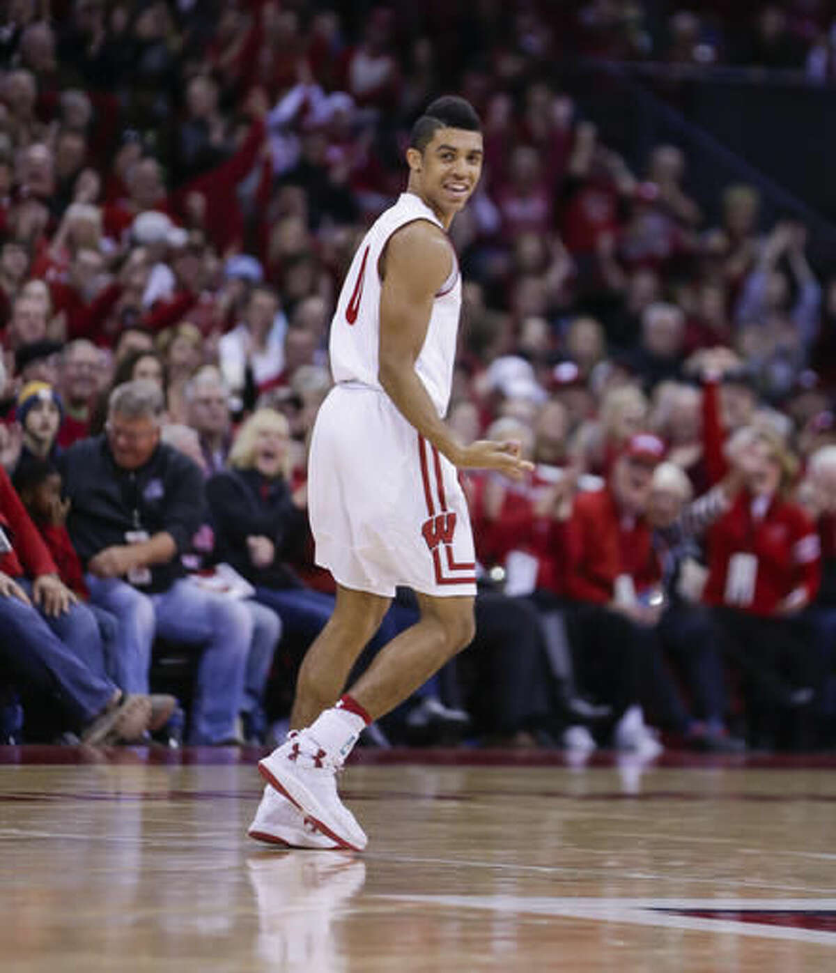 Wisconsin's D'Mitrik Trice (0) reacts after hitting a 3-point basket against Oklahoma during the second half of an NCAA college basketball game Saturday, Dec. 3, 2016, in Madison, Wis. Wisconsin won 90-70. Trice had 16 points in Wisconsin's 90-70 win. (AP Photo/Andy Manis)