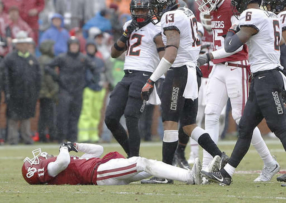 Oklahoma wide receiver Dede Westbrook (11) lays on the field after an injury in a play against Oklahoma State in the first half of an NCAA college football game, Saturday, Dec. 3, 2016, in Norman, Okla. (AP Photo/Alonzo Adams)