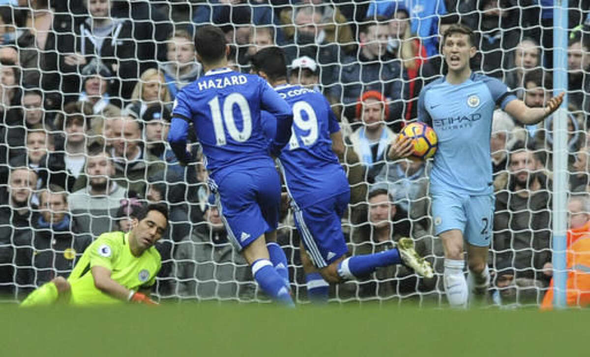 Manchester City's John Stones, right, reacts as Chelsea's Diego Costa, 2nd right runs, during the the English Premier League soccer match between Manchester City and Chelsea at the Etihad Stadium in Manchester, England, Saturday, Dec. 3, 2016. (AP Photo/Rui Vieira)