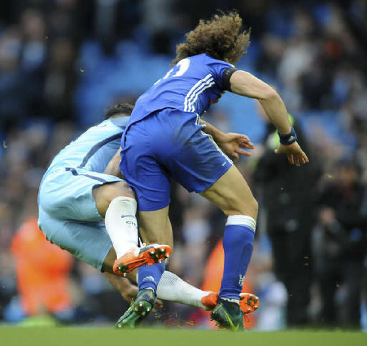 Manchester City's Sergio Aguero, left, is red carded for this tackle on Chelsea's David Luiz during the the English Premier League soccer match between Manchester City and Chelsea at the Etihad Stadium in Manchester, England, Saturday, Dec. 3, 2016. (AP Photo/Rui Vieira)