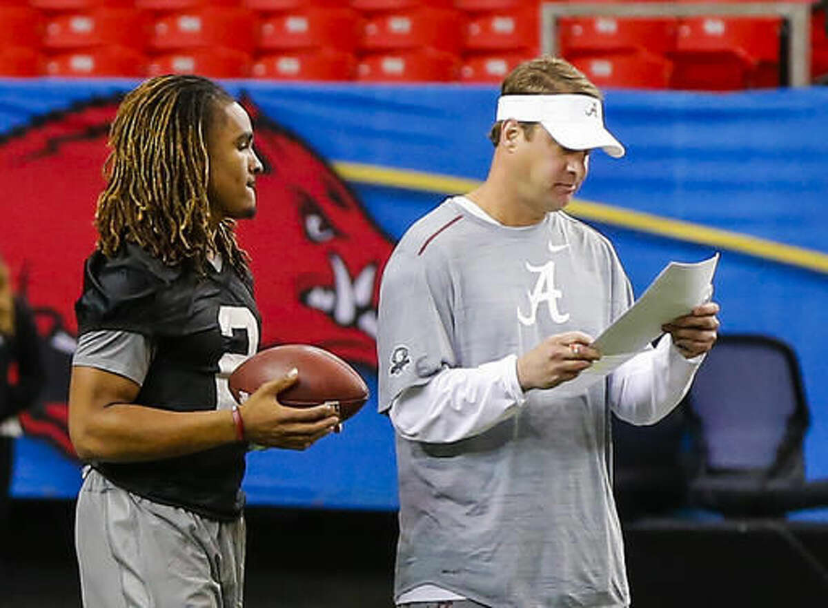 Alabama offensive coordinator Lane Kiffin, right, talks with quarterback Jalen Hurts (2) during practice for the Southeastern Conference Championship NCAA college football game where they will play Florida, Friday, Dec. 2, 2016, in Atlanta. (AP Photo/Butch Dill)