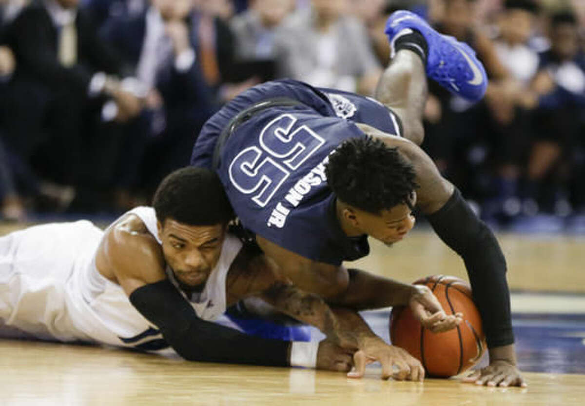 Akron's Antino Jackson (55) leaps for a loose ball against Creighton's Maurice Watson Jr. (10) during the first half of an NCAA college basketball game in Omaha, Neb., Saturday, Dec. 3, 2016. (AP Photo/Nati Harnik)