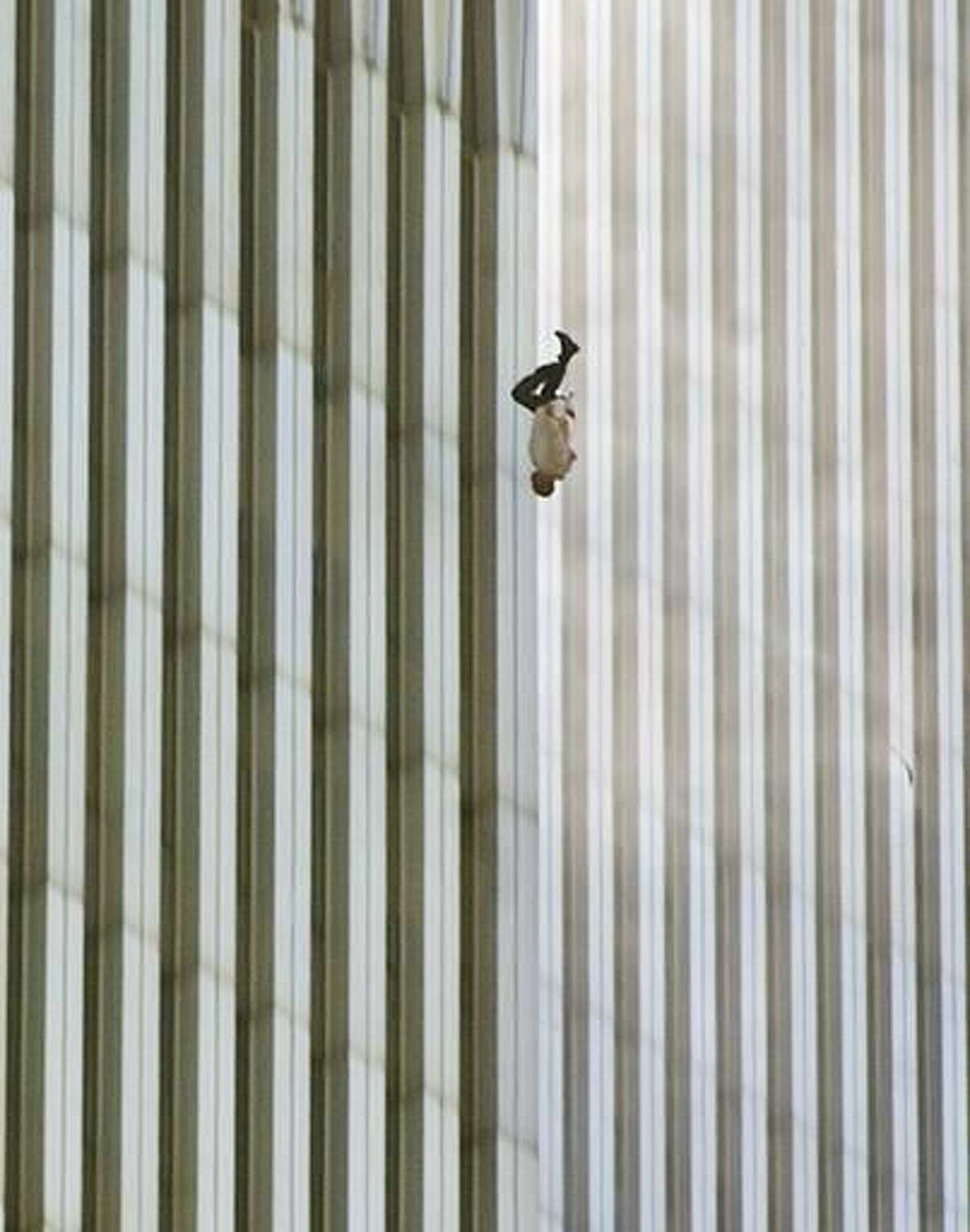 FILE - In this Tuesday, Sept. 11, 2001 file picture, a person falls headfirst from the north tower of New York's World Trade Center. This iconic image is included in Time magazine's most influential images of all time, released Thursday, Nov. 17, 2016, through a new book, videos and a website, Time.com/100photos. (AP Photo/Richard Drew, File)