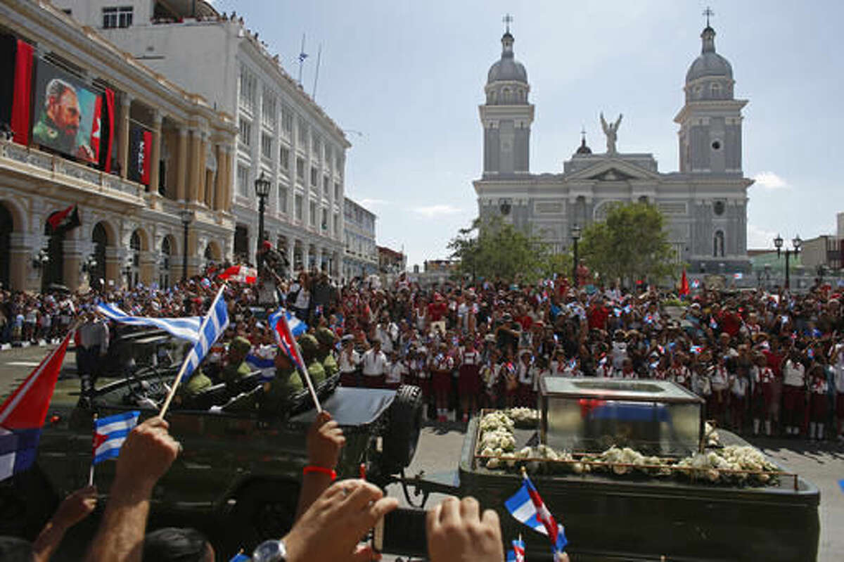 People chant "I am Fidel!" as the motorcade carrying the ashes of the late Cuban leader Fidel Castro leaves Cespedes park in Santiago, Cuba, Saturday, Dec. 3, 2016. After days of national mourning and a tour of his ashes through the countryside, his remains have arrived to the city where they will be laid to rest. (AP Photo/Dario Lopez-Mills)