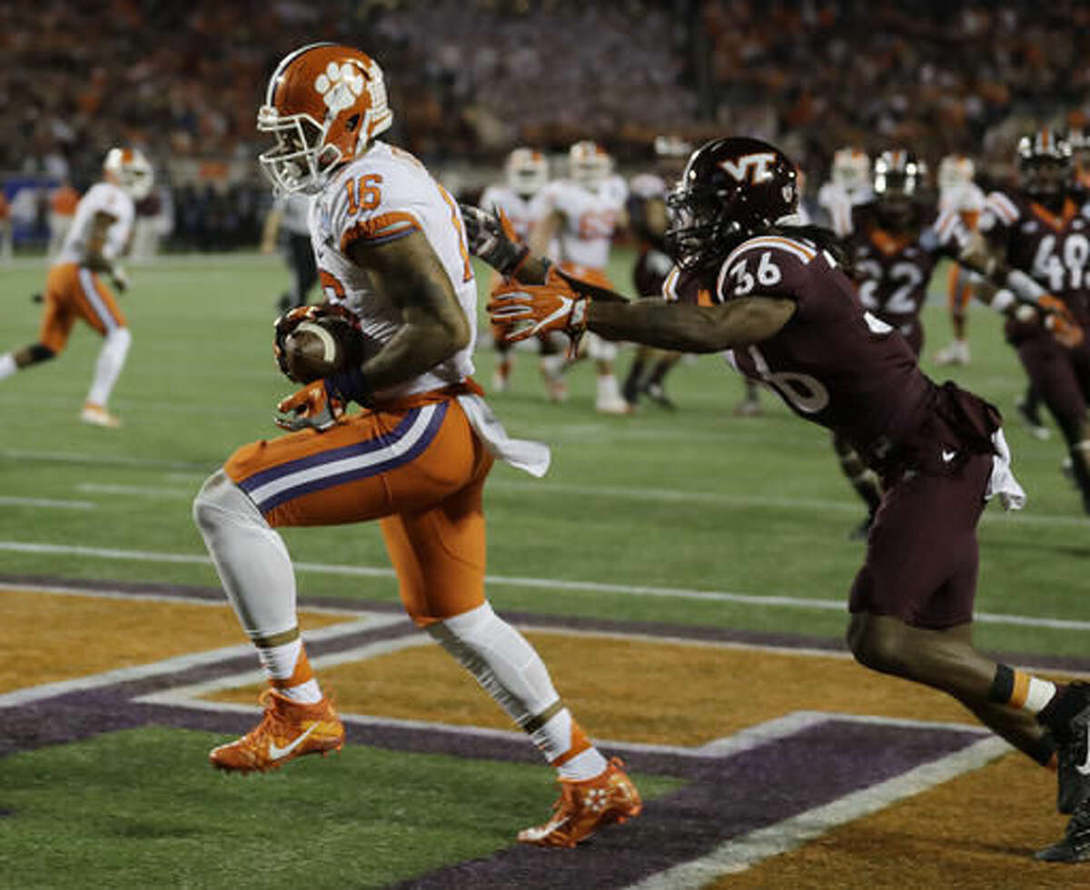 Clemson tight end Jordan Leggett (16) scores a touchdown as Virginia Tech cornerback Adonis Alexander (36) is late with the tackle, during the first half of the Atlantic Coast Conference championship NCAA college football game, Saturday, Dec. 3, 2016, in Orlando, Fla. (AP Photo/Chris O'Meara)