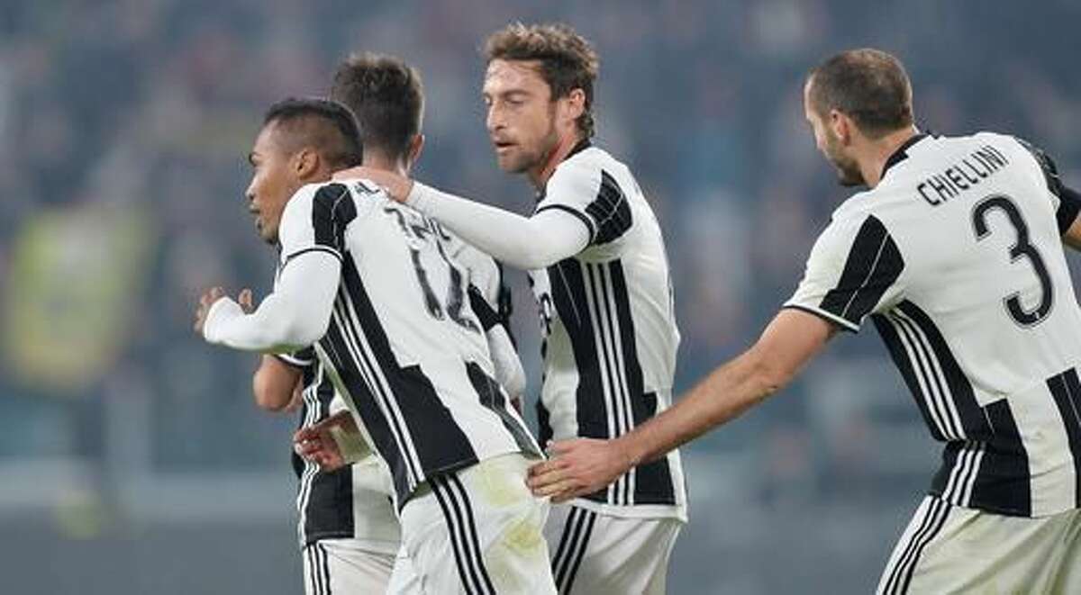 Juventus' Alex Sandro, left, celebrates with his teammates after scoring during a Serie A soccer match between Juventus and Atalanta, at the Juventus Stadium in Turin, Italy, Saturday, Dec. 3, 2016. (Alessandro Di Marco/ANSA via AP)