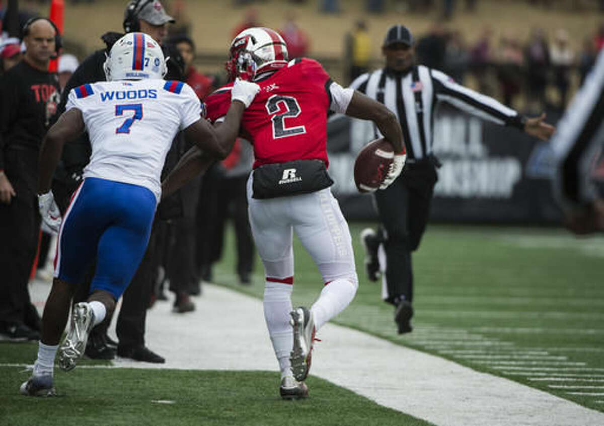 Louisiana Tech safety Xavier Woods (7) pulls Western Kentucky wide receiver Taywan Taylor (2) out of bounds during the first half of the Conference USA championship NCAA college football game, Saturday, Dec. 3, 2016, at L.T. Smith Stadium in Bowling Green, Ky. (AP Photo/Michael Noble Jr.)