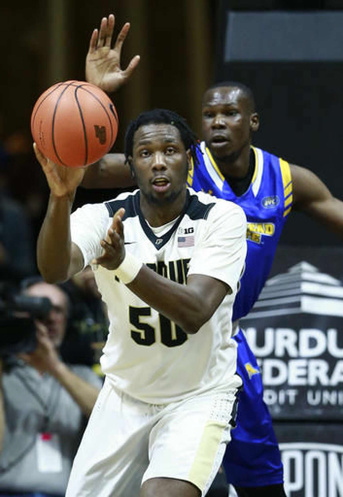 Purdue forward Caleb Swanigan (50) passes the basketball defended by Morehead State forward Keion Alexander in the first half of an NCAA college basketball game, Saturday, Dec. 3, 2016, in West Lafayette, Ind. Purdue won 90-56. (AP Photo/R Brent Smith)