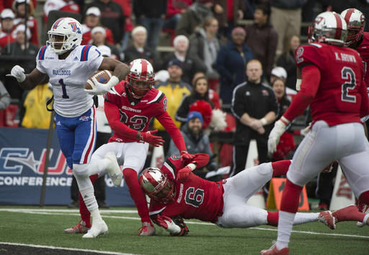 Louisiana Tech wide receiver Carlos Henderson (1) pushes through the Western Kentucky defense to score in the first half of the Conference USA championship NCAA college football game, Saturday, Dec. 3, 2016, at L.T. Smith Stadium in Bowling Green, Ky. (AP Photo/Michael Noble Jr.)